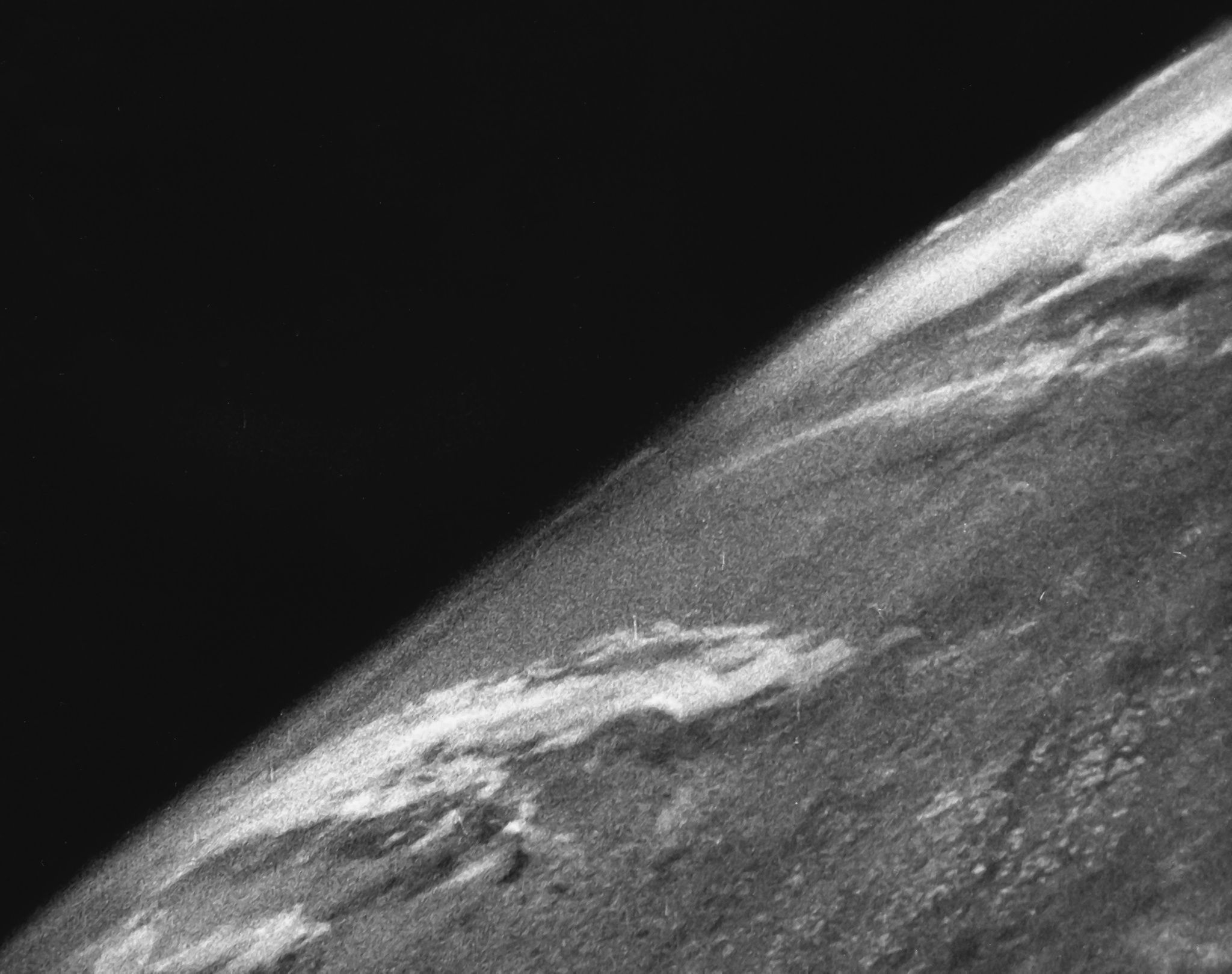 Grainy black and white photograph of Earth from about 105 km, taken from a V-2 rocket in 1946